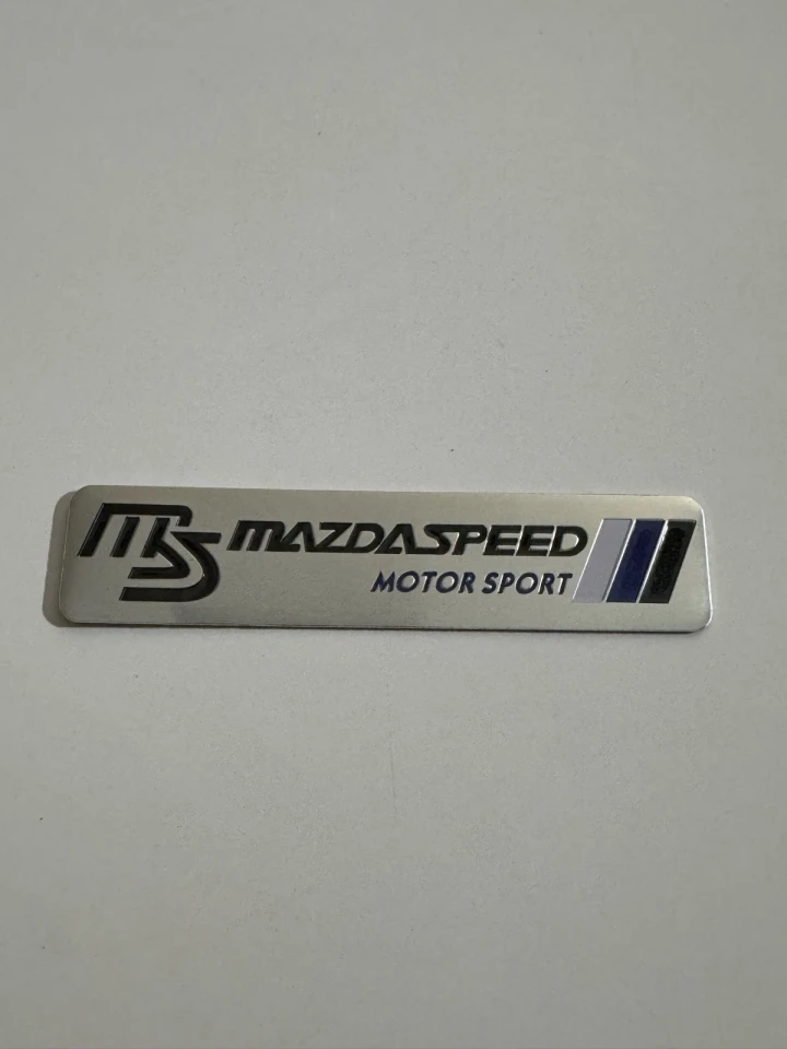 Емблема металева MAZDASPEED (12х2.6 см) хром-чорна на скотчі