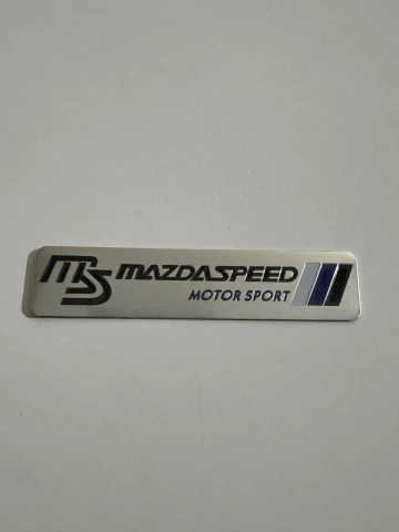 Емблема металева MAZDASPEED (12х2.6 см) хром-чорна на скотчі